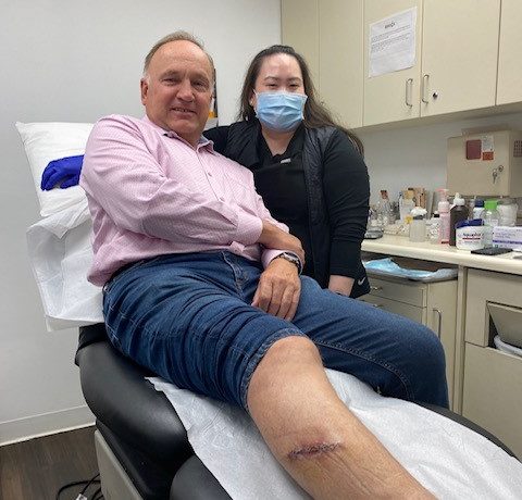 man with melanoma surgical incision on leg