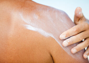 Woman applying sunscreen, Maldives